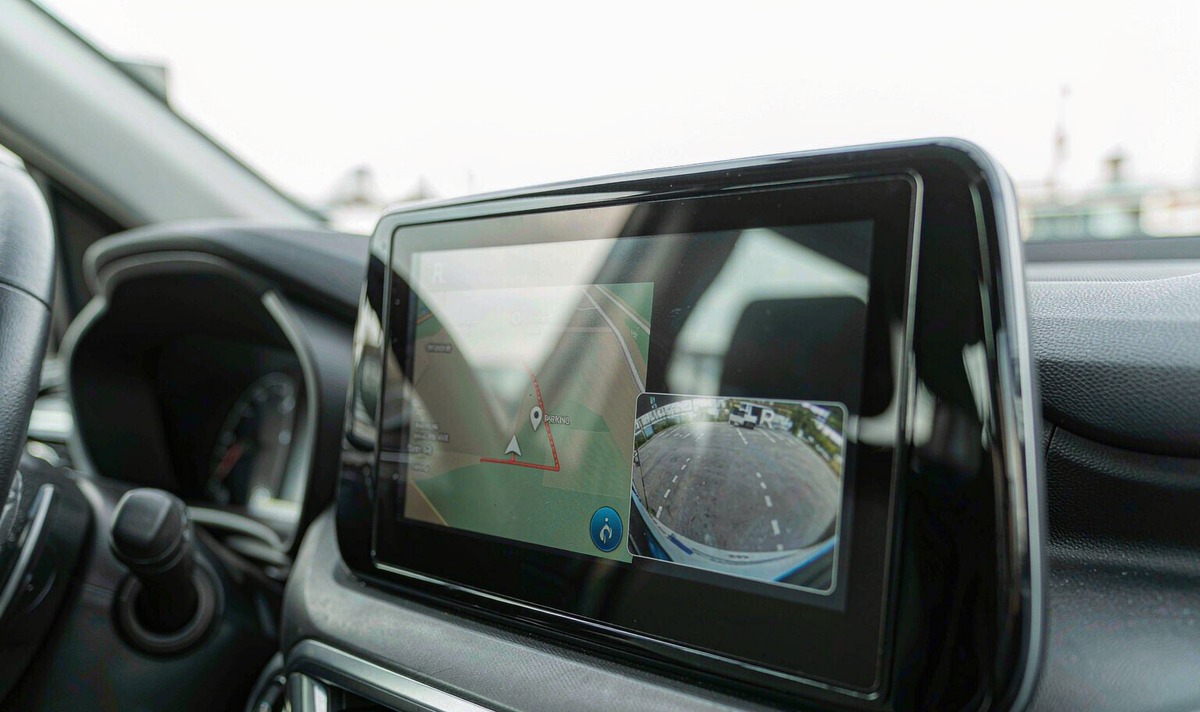 Retrofit Android car radio screen in a car with a street map running and a small rear camera picture floating over the lower right of the display