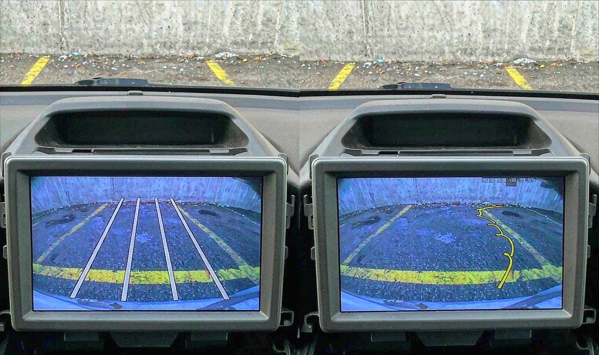 Two car stereo screens side by side showing a reversing view with fixed straight guide lines on one and bending reverse camera guide lines on the other