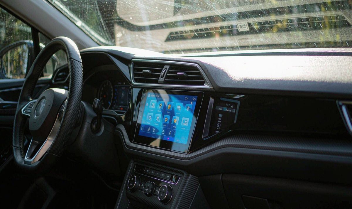 12.3 inch android car stereo aftermarket dash kit installed in a dashboard, retain original factory features, with sunlight crossing the panel