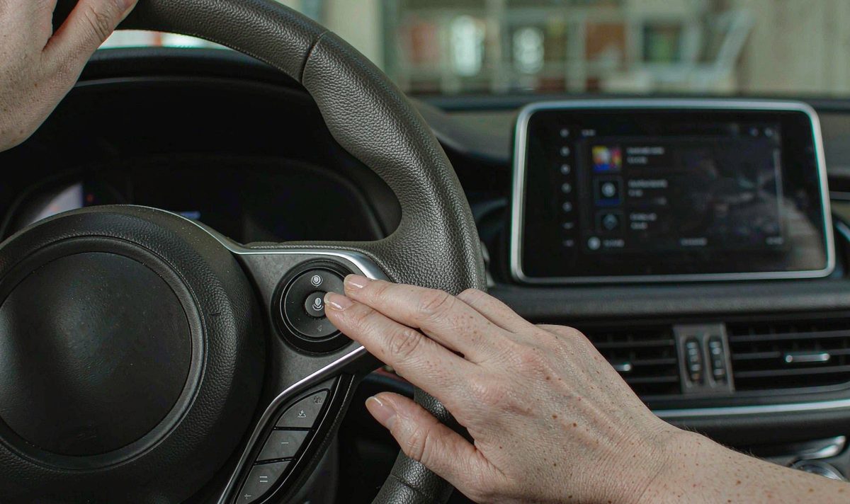 Driver pressing the steering wheel voice button to ask the car screen android head unit dash kit, retain original factory features