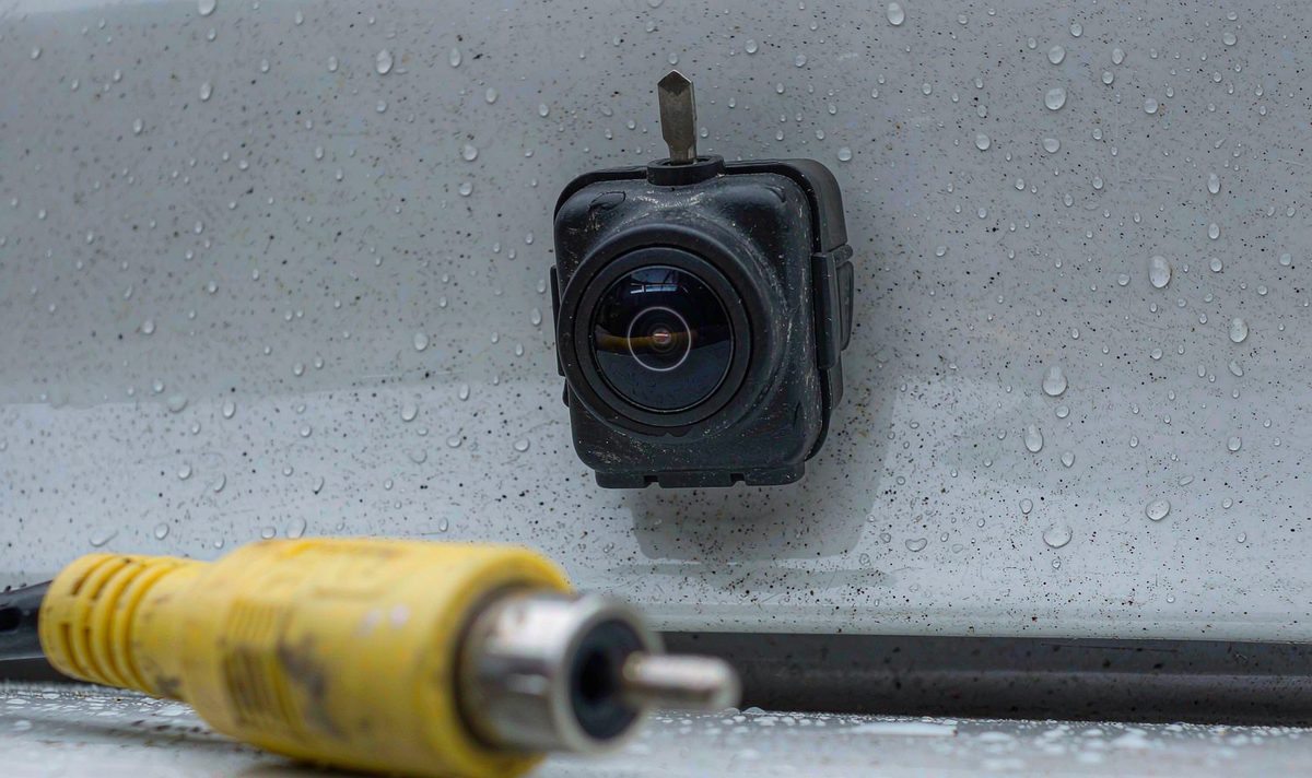 Reversing camera and yellow RCA video plug close up car stereo head unit aftermarket dash kit, retain original factory features, the connector that carries the camera picture