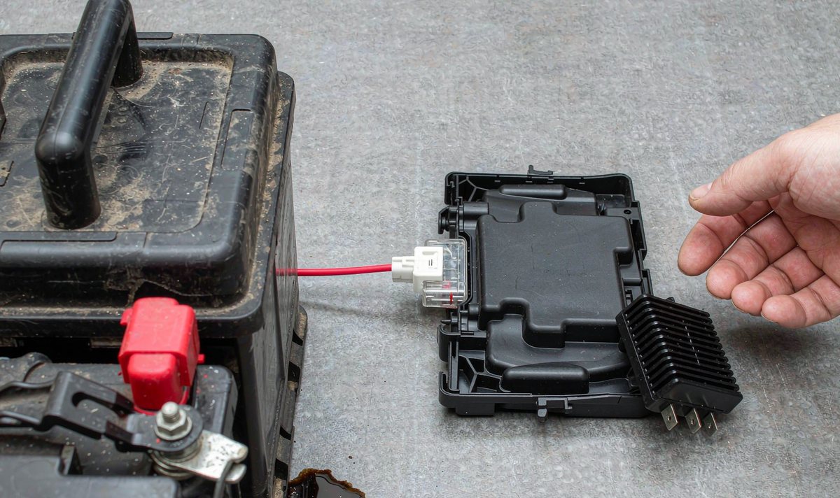 Hardwire kit tapped into a car battery and fuse box to feed constant power to the head unit with a voltage cutoff in place