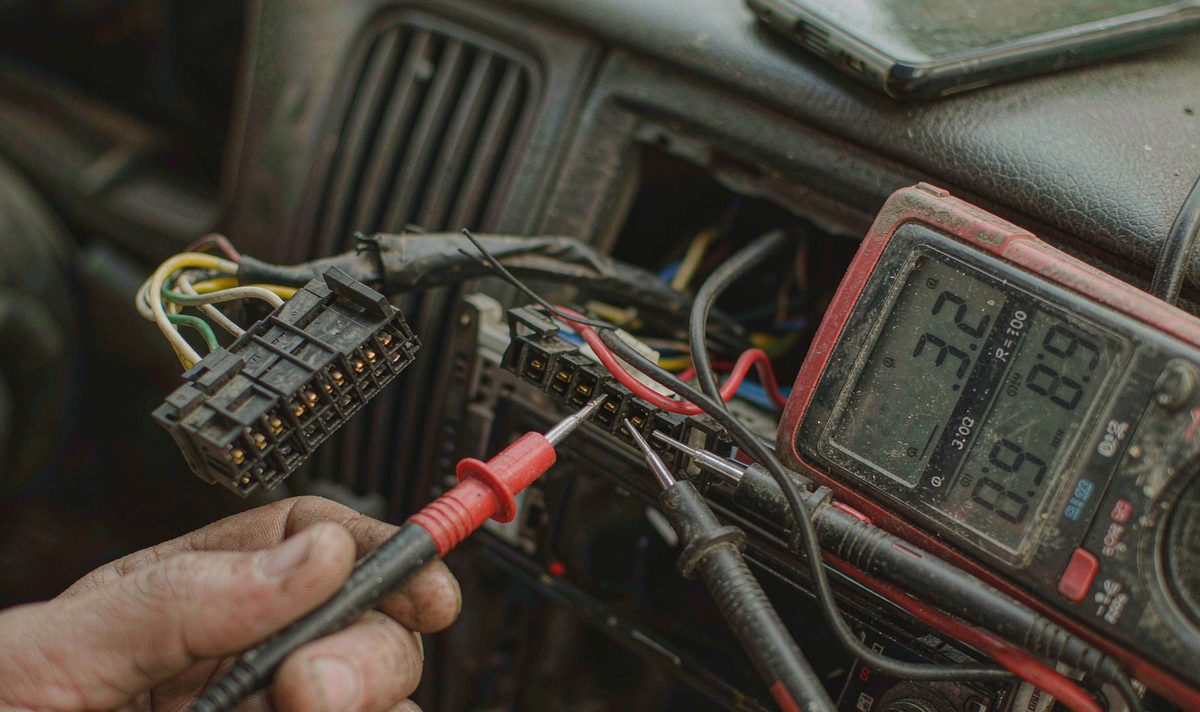 Multimeter speaker resistance test android head unit aftermarket wiring harness, retain original factory features, probes touching speaker wires at a car stereo connector