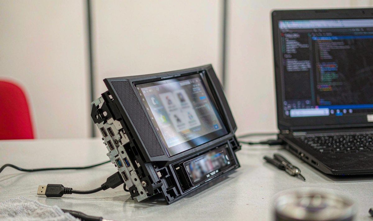 Custom font install on an android head unit aftermarket dash kit, retain original factory features, the unit on a bench with a USB cable running to a laptop